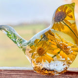 yellow canary resin bird with real yellow daisies, green foliage, and gold leaf base, handmade in Alberta