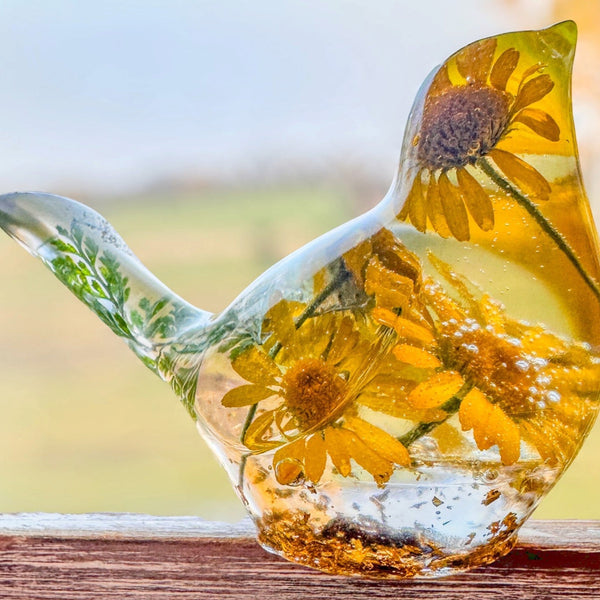 yellow canary resin bird with real yellow daisies, green foliage, and gold leaf base, handmade in Alberta