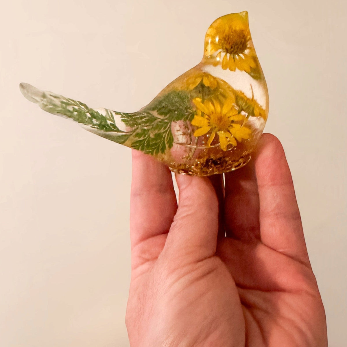 yellow canary resin bird with real yellow daisies, green foliage, and gold leaf base, handmade in Alberta