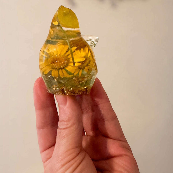 yellow canary resin bird with real yellow daisies, green foliage, and gold leaf base, handmade in Alberta
