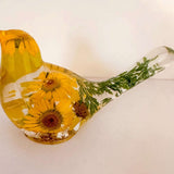 yellow canary resin bird with real yellow daisies, green foliage, and gold leaf base, handmade in Alberta