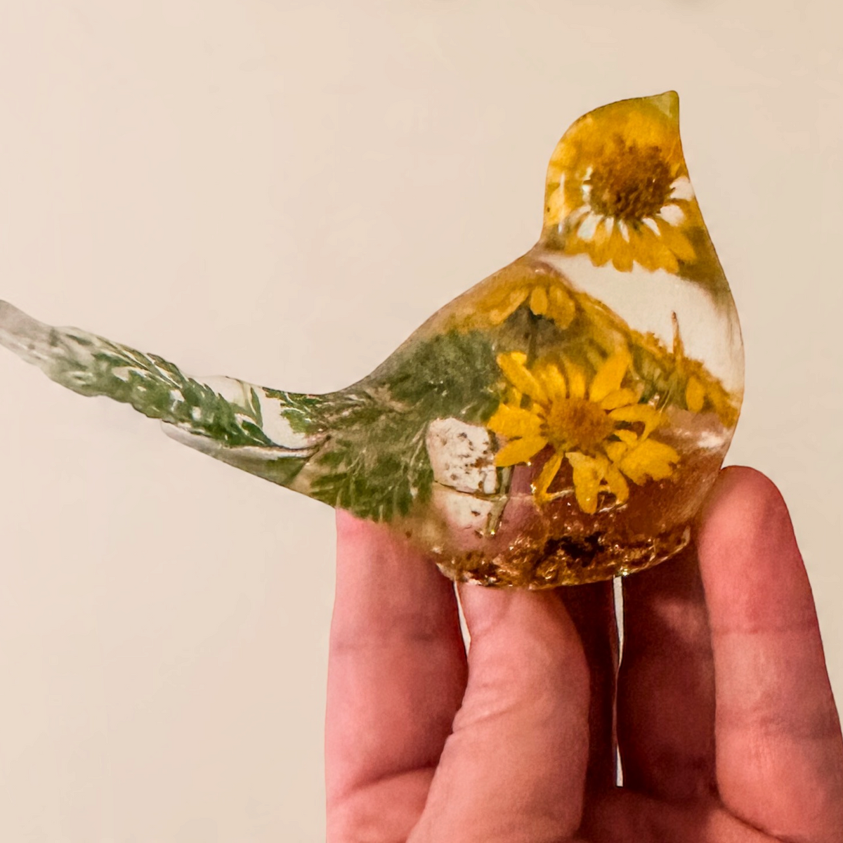 yellow canary resin bird with real yellow daisies, green foliage, and gold leaf base, handmade in Alberta