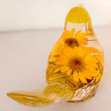 yellow canary resin bird with real yellow daisies, green foliage, and gold leaf base, handmade in Alberta