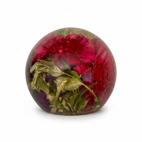Floral resin sphere with dark pink and purple carnations and green botanicals glowing on LED base