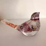 Cherry blossom resin bird held in a hand to show its small size