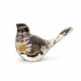 Handmade black and white chickadee figurine with preserved flowers, capturing the spirit of the boreal forest