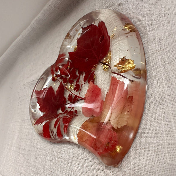 Red maple leaf resin tray with crimson and blush foliage, clear glossy finish, gold leaf flakes and heart shape.