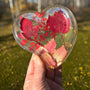 Red maple leaf resin tray in a glossy clear heart shape, with crimson and blush foliage and scattered gold flakes.