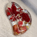 Red maple leaf resin tray in a clear heart shape, with crimson and blush foliage, gold leaf flakes and a glossy finish.