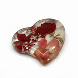 Heart-shaped red maple leaf resin tray with clear glossy resin, preserved crimson and blush foliage, and scattered gold leaf.