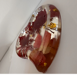 Red maple leaf resin tray in a heart shape, with crimson and blush foliage, clear glossy resin and scattered gold leaf.
