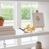 Spring Bloom Duo daffodil resin bird pair facing each other on a bright white shelf