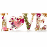 Fuchsia Garden LOVE resin word art with pressed pink and fuchsia flowers, fern fronds, and gold leaf flakes