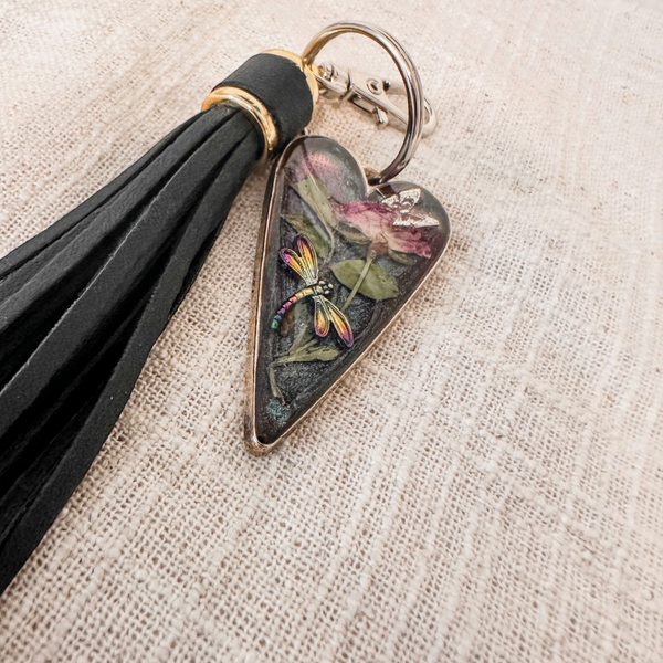 Dragonfly resin keychain with a glossy heart-shaped resin pendant, pressed pink flower, colourful dragonfly and black tassel