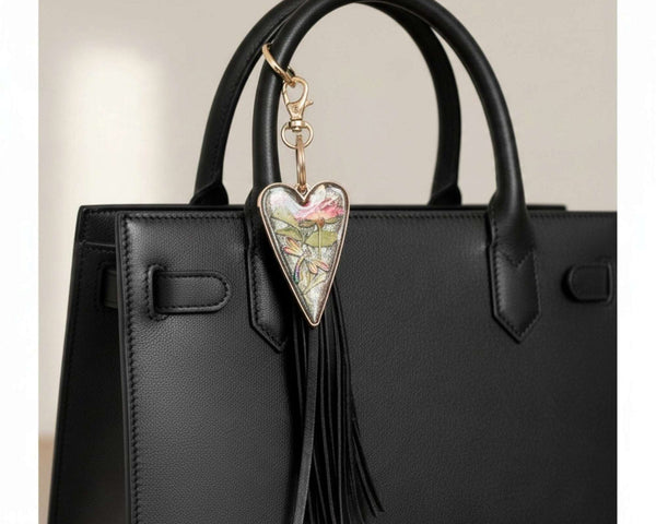dragonfly resin keychain with a silver heart frame, pressed pink flower, colorful dragonfly detail and long black tassel