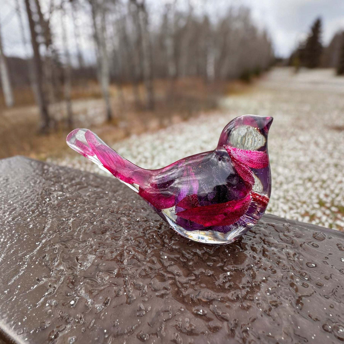 Fuchsia resin bird decor with clear glossy resin, preserved purple and pink blooms, and a long petal-filled tail.