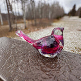 Fuchsia resin bird decor with clear glossy resin, preserved purple and pink blooms, and a long petal-filled tail.