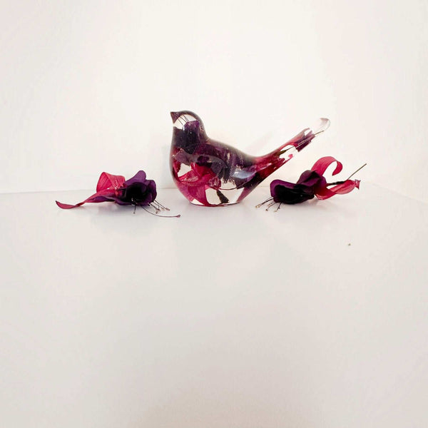 Fuchsia resin bird decor with clear glossy resin, deep purple and crimson pink petals, and a translucent tail.