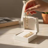 Long organic-edged Floral Butterfly drop earrings featuring tiny white spring flowers and miniature butterflies floating in clear resin.