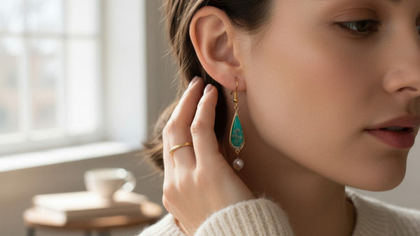 Woman wearing a turquoise earring indoors with a blurred background