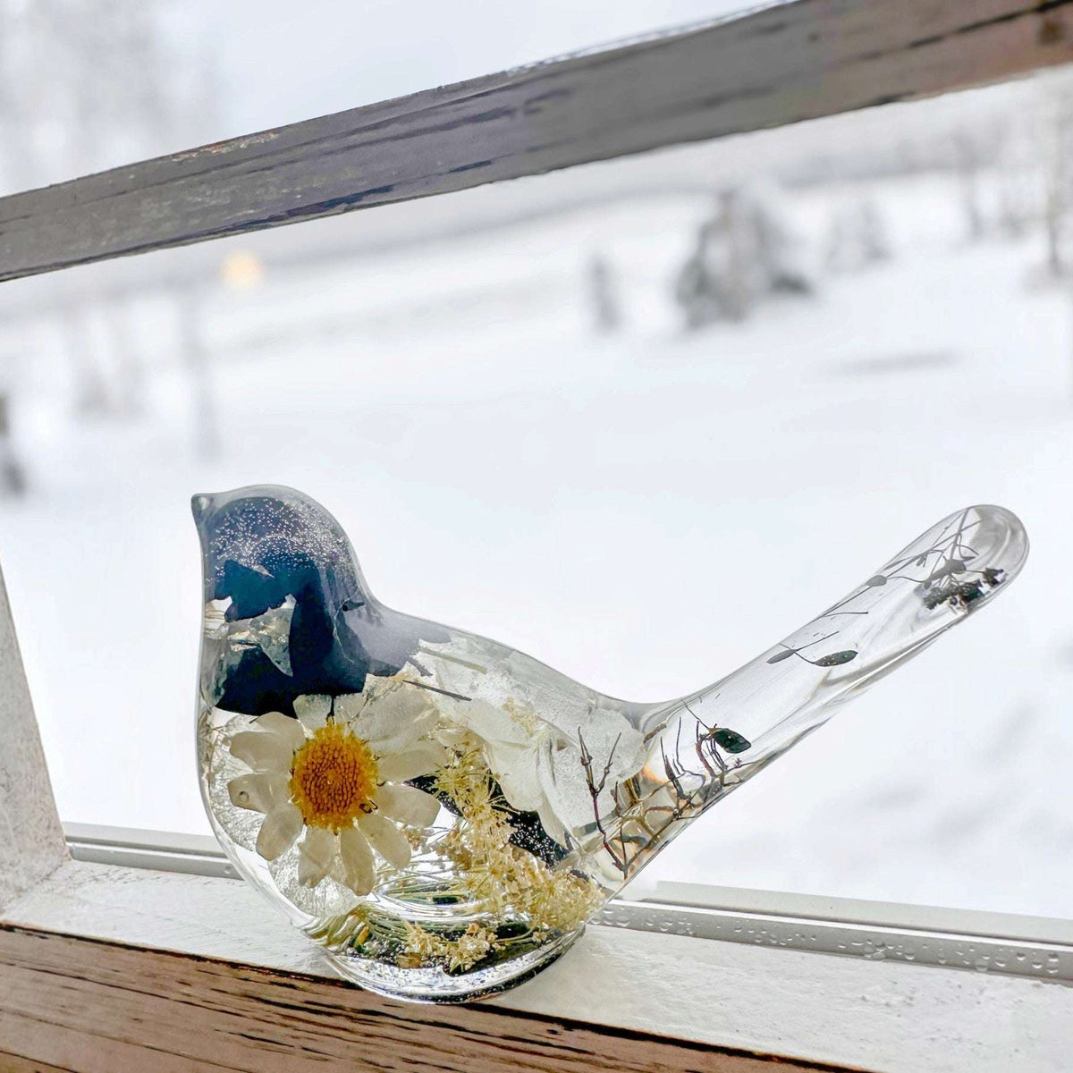 Black and white chickadee resin bird decor showing the dried flowers through the body