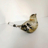 Close up of a handmade chickadee showing black and white dried blooms in resin