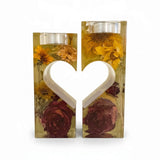 heart tealight holder set of two clear resin pieces with yellow dried flowers, deep red roses, and a heart-shaped center