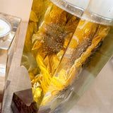heart tealight holder set with clear resin pieces encasing three-dimensional golden dried sunflowers and deep red roses