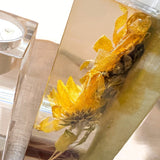 Heart tealight holder set in clear resin with dimensional golden dried sunflowers and a soft sage green backing