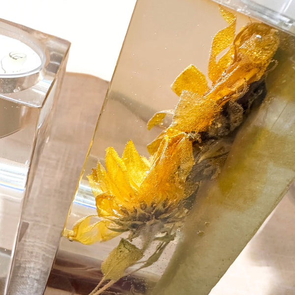 Heart tealight holder set in clear resin with dimensional golden dried sunflowers and a soft sage green backing