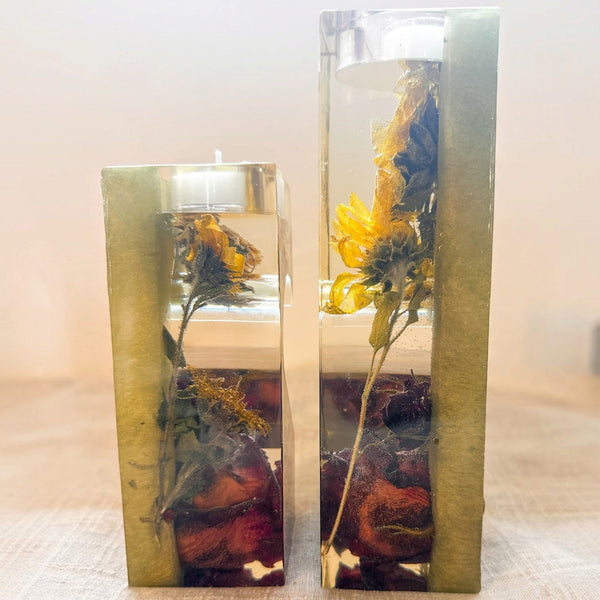 heart tealight holder set in clear resin with sage green sides, dried yellow sunflowers and deep red roses