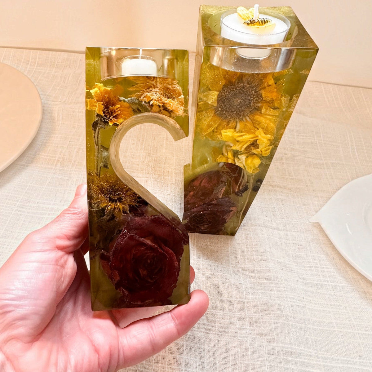 heart tealight holder set in clear amber resin with dried yellow sunflowers, deep red roses and two interlocking pieces