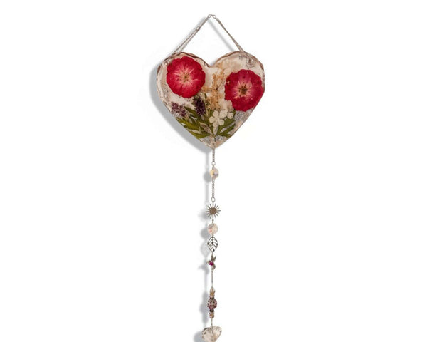 Pressed rose suncatcher featuring two deep crimson roses, green leaves, silver leaf flakes in clear resin, with silver chain and crystal charms.