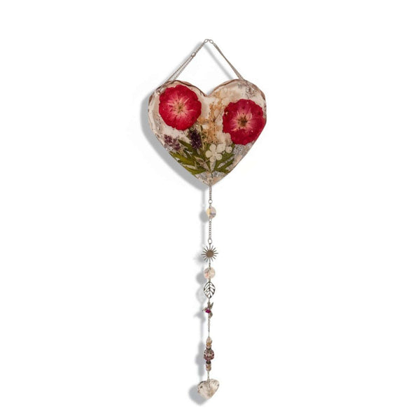 Pressed rose suncatcher featuring two deep crimson roses, green leaves, silver leaf flakes in clear resin, with silver chain and crystal charms.