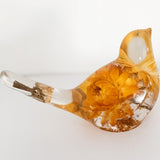 Yellow Strawflower Resin Bird with clear resin body, amber-gold dried flowers, and a transparent tail holding a dried bud.