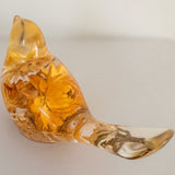 Yellow Strawflower Resin Bird with amber-gold dried flowers embedded in clear resin and a transparent tail with a stem detail.