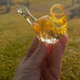 Yellow Strawflower Resin Bird figurine in clear resin with golden yellow dried flowers, translucent head and tail, and gold flecks at the base.