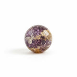 Purple lilac resin sphere with real lilac and hydrangea flowers illuminated on LED base