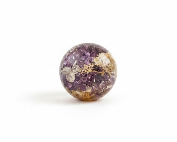 Purple lilac resin sphere with real lilac and hydrangea flowers illuminated on LED base