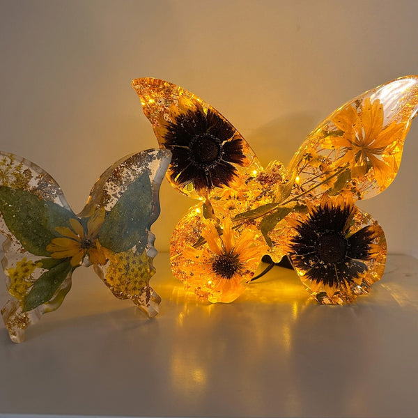light up resin butterfly decor set with two translucent amber resin butterflies, embedded yellow flowers and dark centers