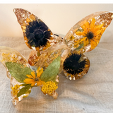 Light up resin butterfly decor set with two clear resin butterflies, featuring golden flowers, green leaves and gold flecks
