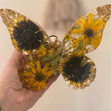 light up resin butterfly decor, clear resin butterfly with yellow sunflowers, dark centres, green leaves and gold flecks