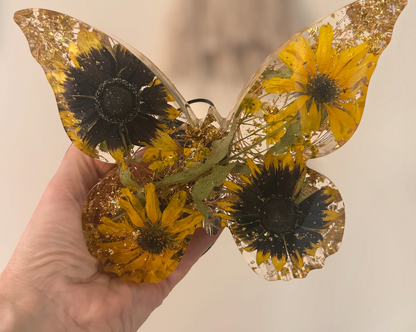 light up resin butterfly decor, clear resin butterfly with yellow sunflowers, dark centres, green leaves and gold flecks