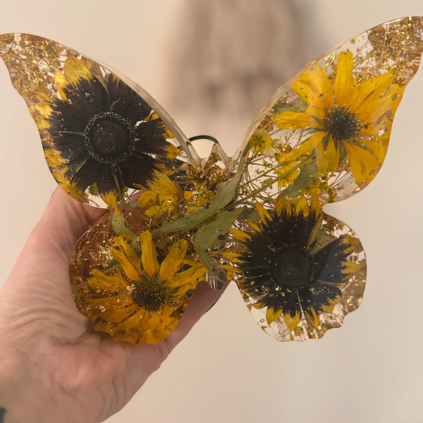 light up resin butterfly decor, clear resin butterfly with yellow sunflowers, dark centres, green leaves and gold flecks