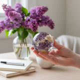 Purple lilac resin sphere with real lilac and white hydrangea blooms glowing on LED base