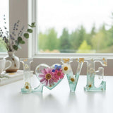 Handcrafted floral resin LOVE sign with a large pink cosmo and forest green base.