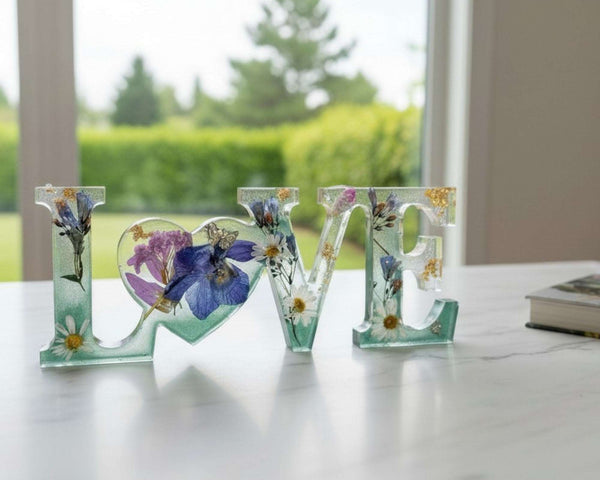Handcrafted "LOVE" floral resin sign with deep green and clear layers.