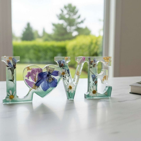 Handcrafted "LOVE" floral resin sign with deep green and clear layers.