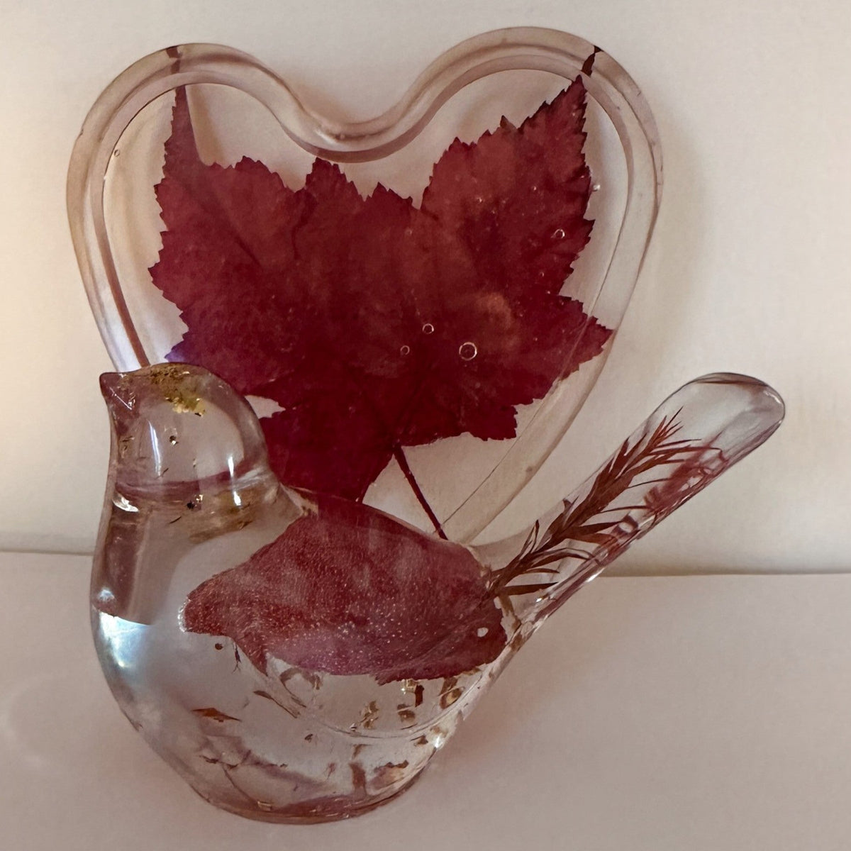 Maple leaf bird and tray set in clear glossy resin, with a red maple leaf heart tray and bird featuring gold flecks and botanical details.