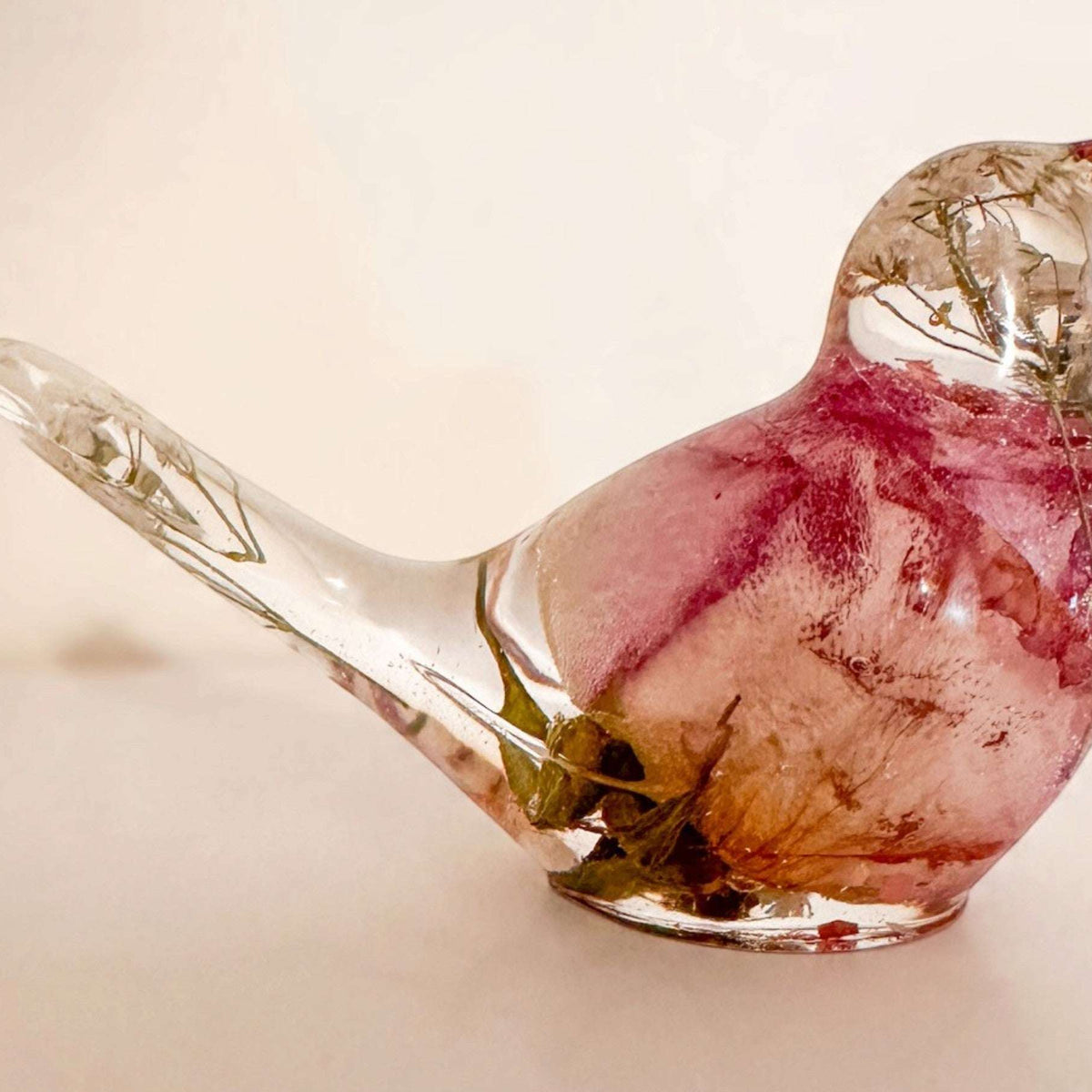 Memorial resin bird, a handmade keepsake holding real dried flowers in clear resin